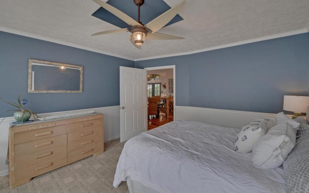 1431 Tame Turkey Road Lakemont, GA 30552 - Photo 19 of 62 a bedroom with a large bed and a chandelier