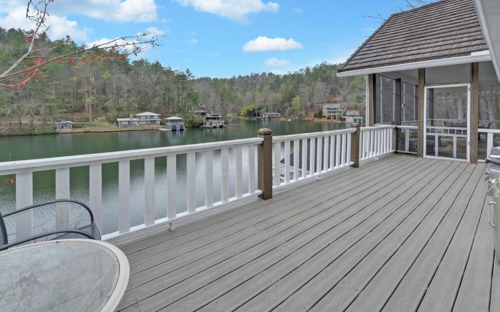 1431 Tame Turkey Road Lakemont, GA 30552 - Photo 24 of 62 a balcony with wooden floor table and chairs