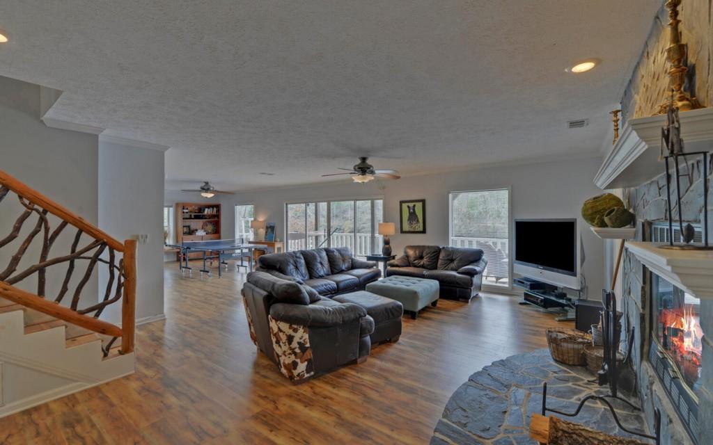 1431 Tame Turkey Road Lakemont, GA 30552 - Photo 27 of 62 a living room with fireplace furniture and a flat screen tv
