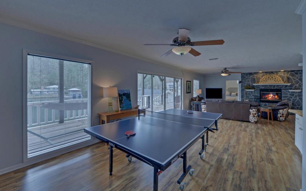 1431 Tame Turkey Road Lakemont, GA 30552 - Photo 29 of 62 a living room with furniture a dining table and a fireplace