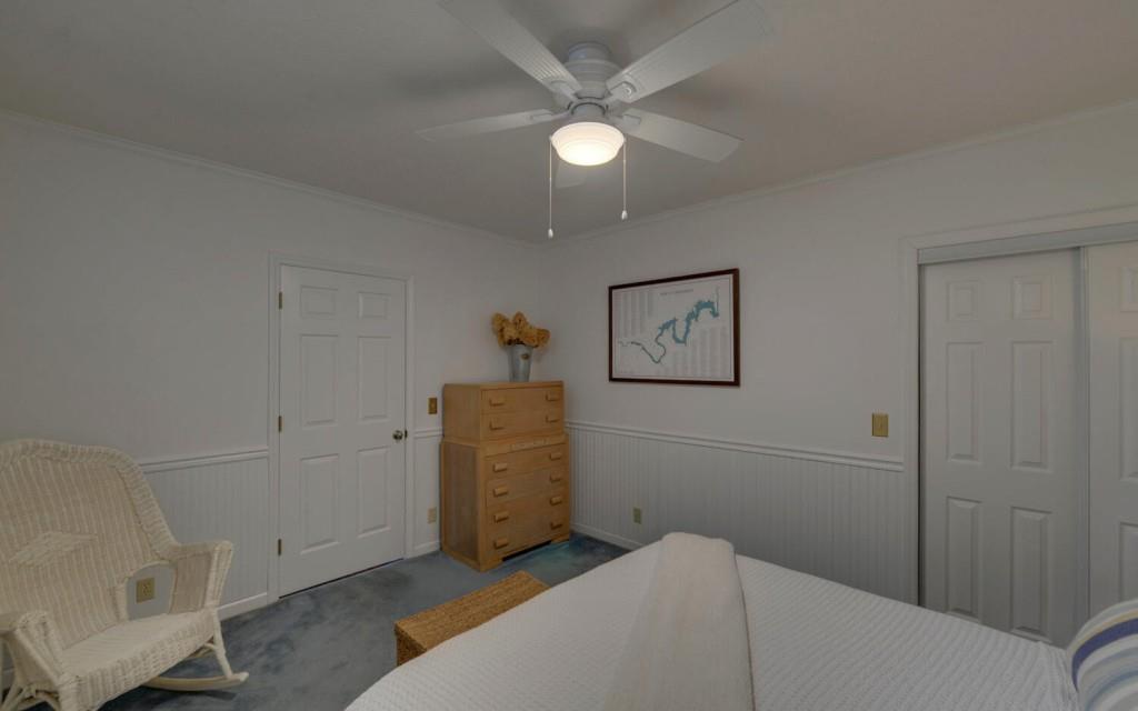 1431 Tame Turkey Road Lakemont, GA 30552 - Photo 31 of 62 a bedroom with a bed and a chandelier