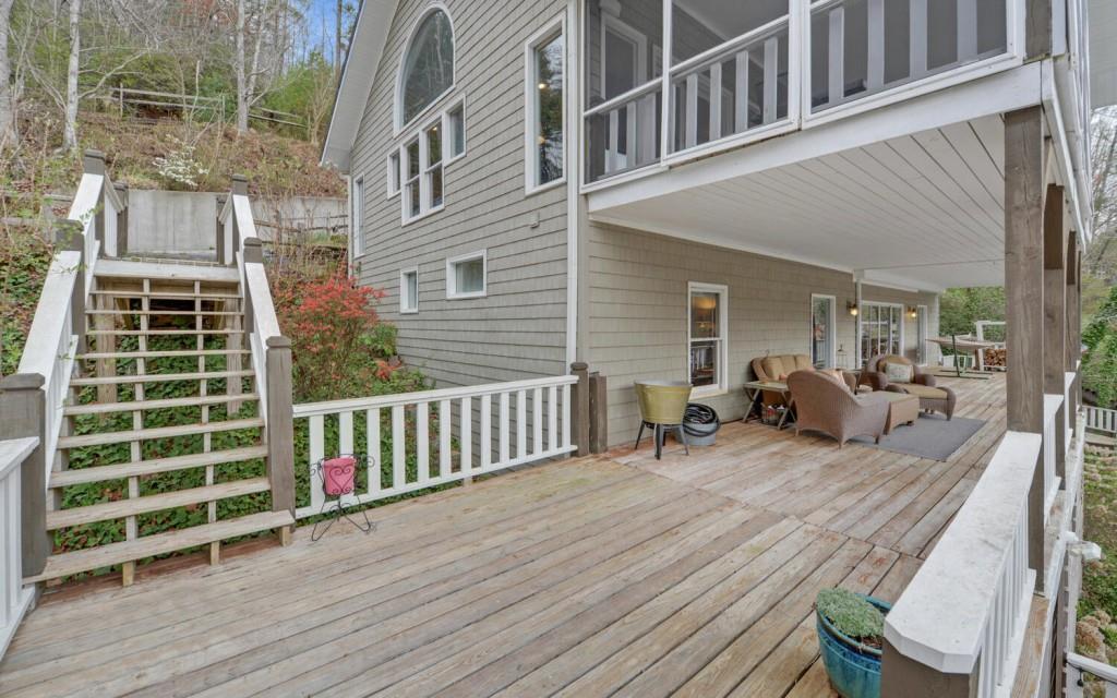 1431 Tame Turkey Road Lakemont, GA 30552 - Photo 38 of 62 a view of a deck with couches chairs and wooden floor
