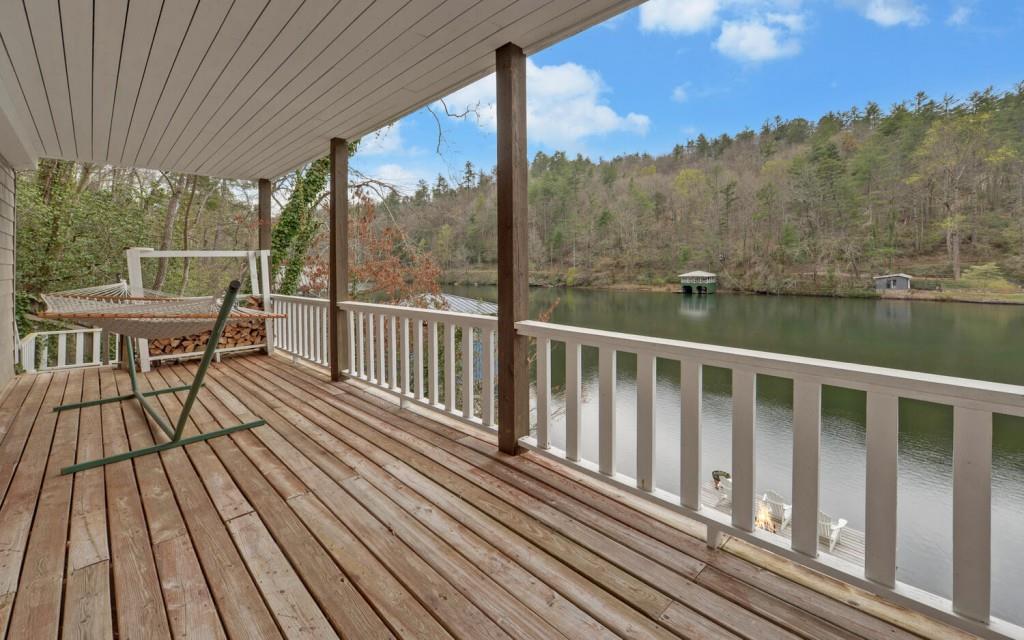 1431 Tame Turkey Road Lakemont, GA 30552 - Photo 42 of 62 a view of a balcony with chairs and wooden floor