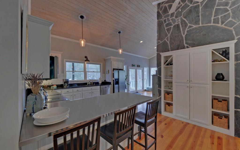 1431 Tame Turkey Road Lakemont, GA 30552 - Photo 10 of 62 a kitchen with kitchen island a table and chairs in it