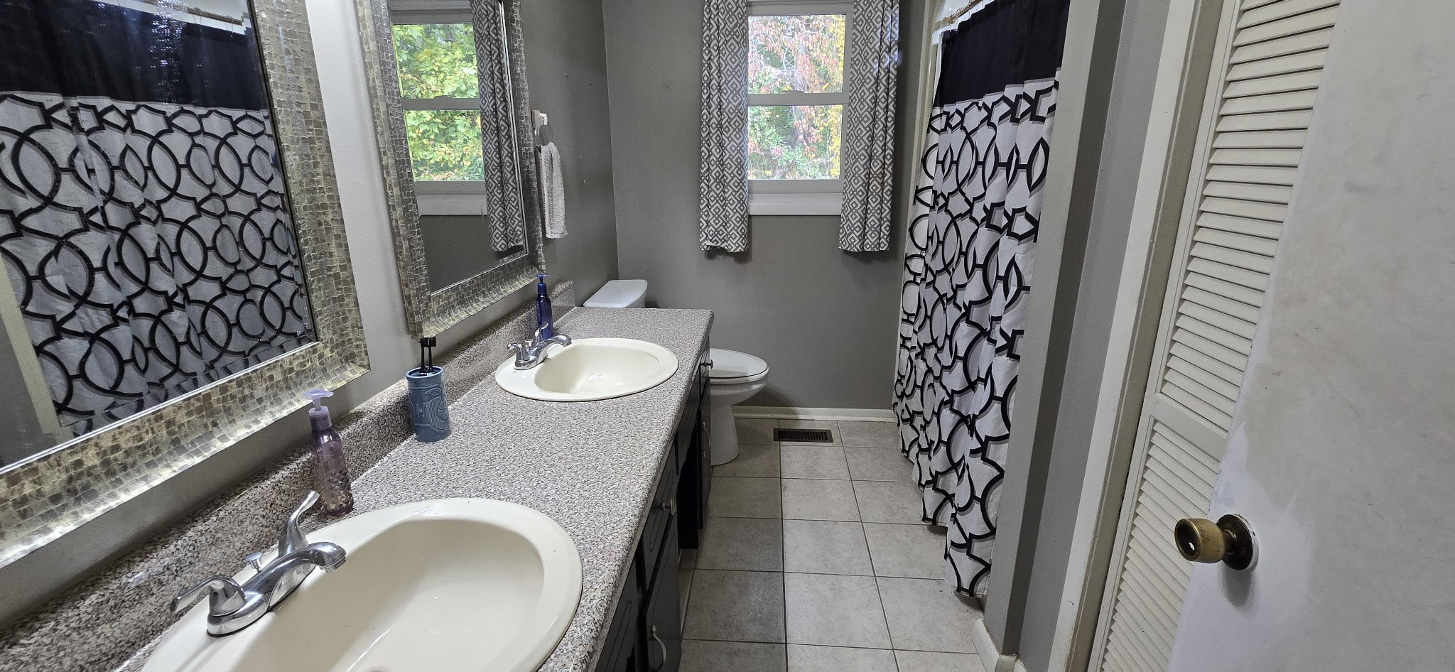 936 Ridge Road Quebeck, TN 38579 - Photo 26 of 32 a bathroom with a granite countertop sink a toilet and shower curtain