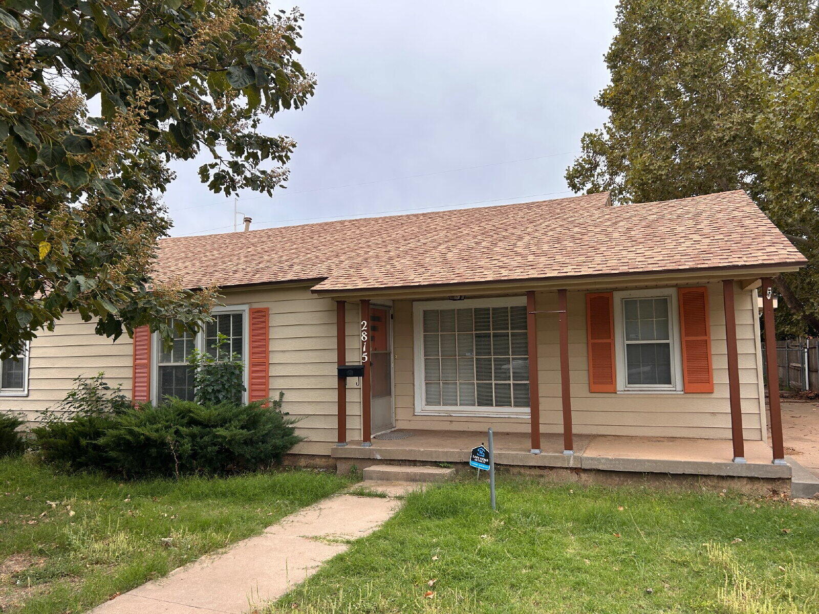 2815 33rd Street Lubbock, TX 79410 - Photo 1 of 9 a front view of a house with a garden and yard