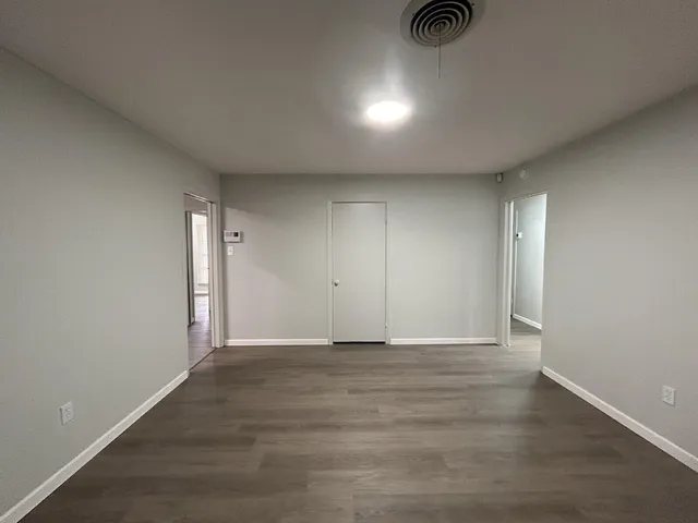 a view of an empty room and wooden floor