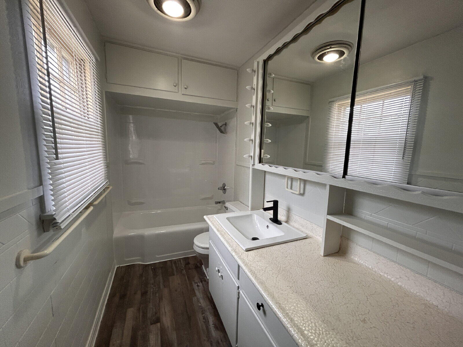 2815 33rd Street Lubbock, TX 79410 - Photo 3 of 9 a bathroom with a sink and a mirror