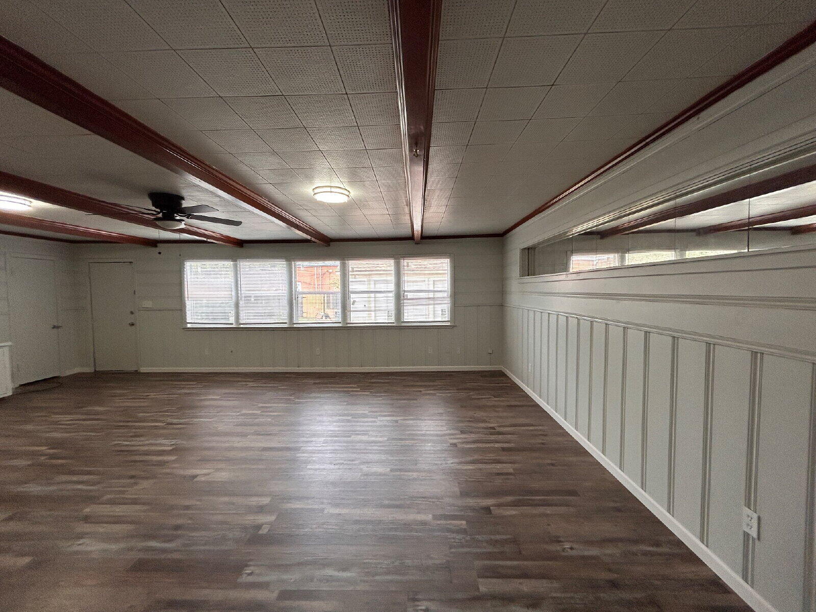 2815 33rd Street Lubbock, TX 79410 - Photo 5 of 9 a view of an empty room with wooden floor and a window