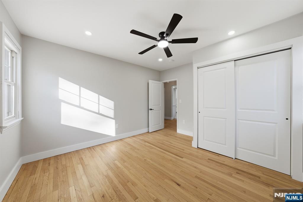 25 Forest Street Closter, NJ 07624 - Photo 12 of 48 a view of an empty room with wooden floor and a window