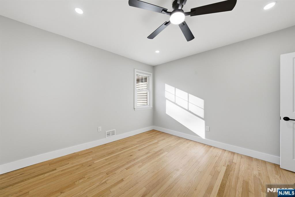 25 Forest Street Closter, NJ 07624 - Photo 13 of 48 wooden floor in an empty room with a window