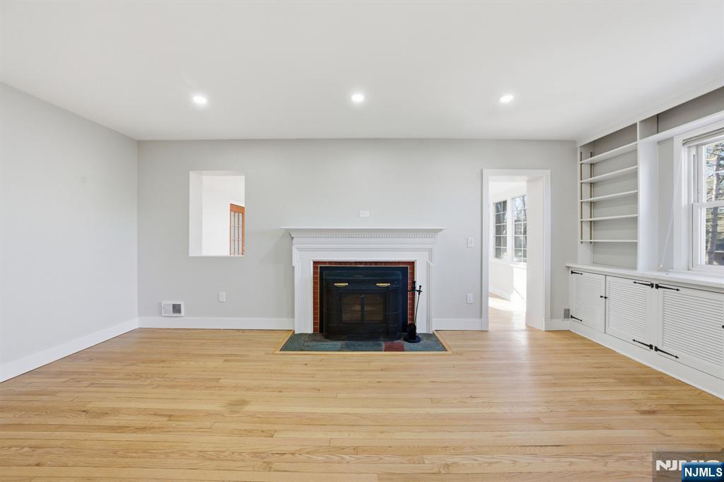 25 Forest Street Closter, NJ 07624 - Photo 15 of 48 a view of empty room with wooden floor and fireplace
