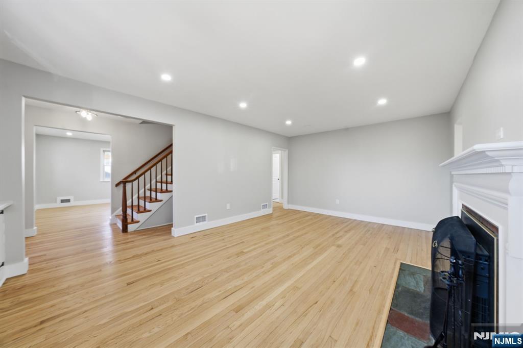 25 Forest Street Closter, NJ 07624 - Photo 16 of 48 a view of a hallway with wooden floor and staircase