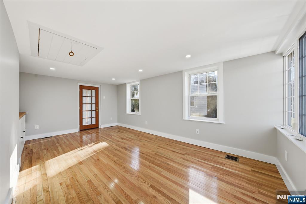 25 Forest Street Closter, NJ 07624 - Photo 17 of 48 a view of an empty room with window and wooden floor