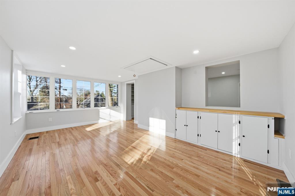 25 Forest Street Closter, NJ 07624 - Photo 19 of 48 a view of an empty room with wooden floor and a window