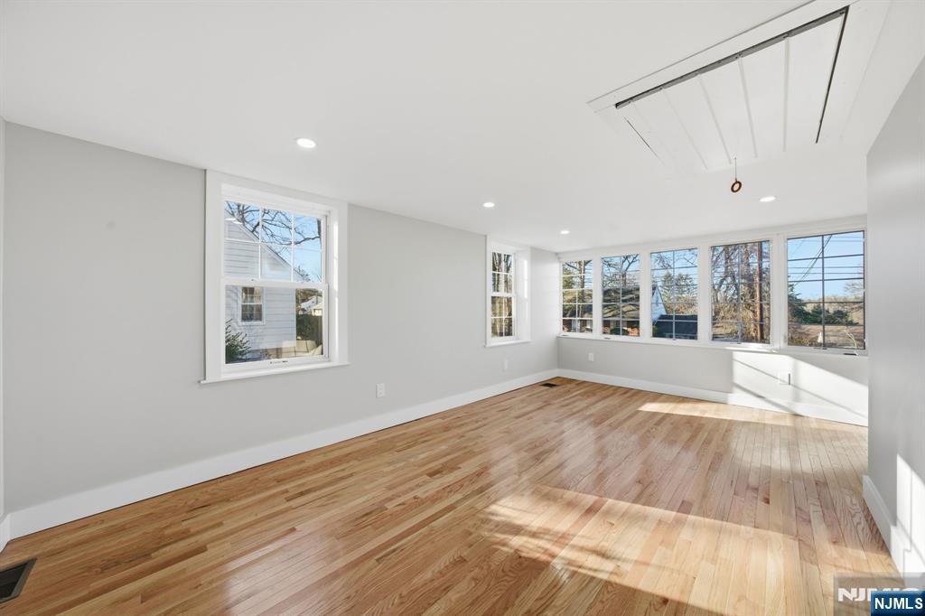 25 Forest Street Closter, NJ 07624 - Photo 20 of 48 a view of an empty room with a window and wooden floor