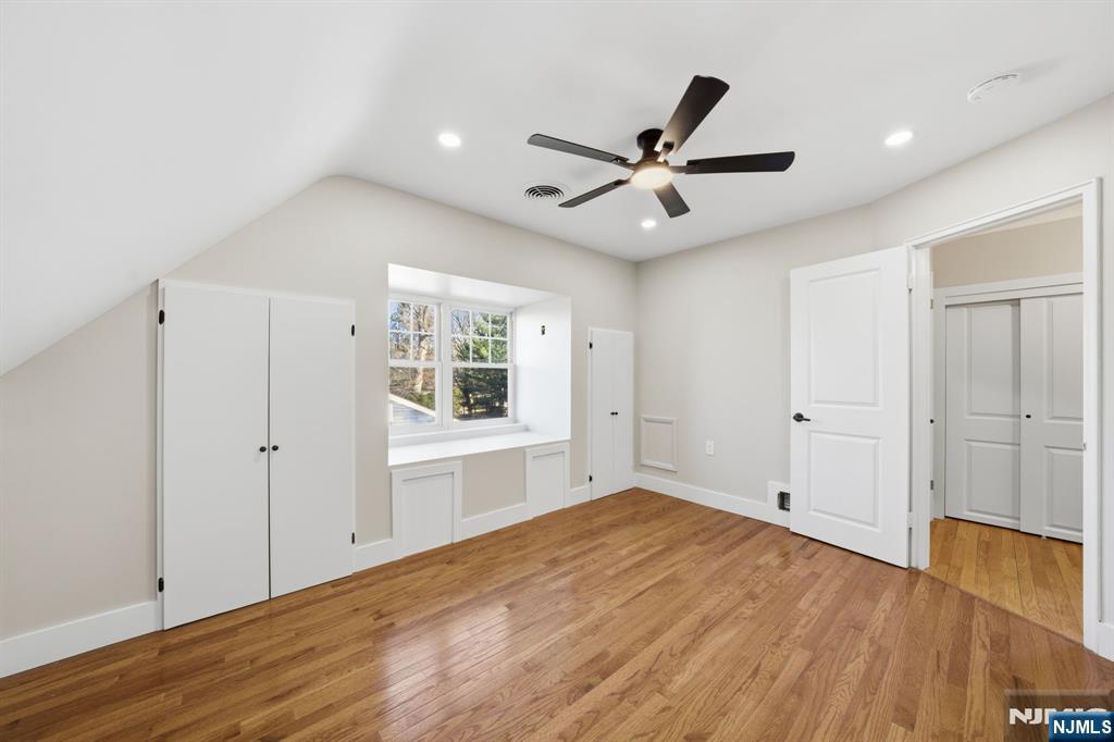 25 Forest Street Closter, NJ 07624 - Photo 26 of 48 a view of an empty room with wooden floor and a ceiling fan