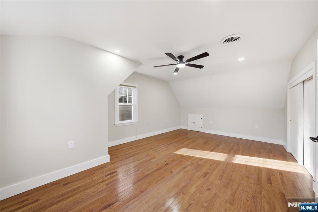 25 Forest Street Closter, NJ 07624 - Photo 27 of 48 an empty room with wooden floor and windows