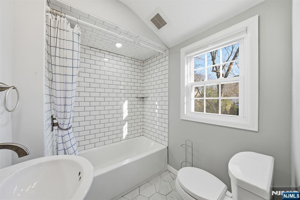 25 Forest Street Closter, NJ 07624 - Photo 31 of 48 a bathroom with a toilet a sink and bathtub