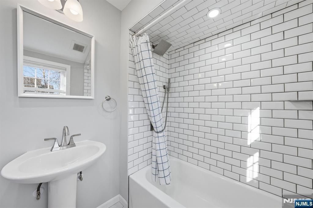 25 Forest Street Closter, NJ 07624 - Photo 32 of 48 a bathroom with a sink a toilet and shower