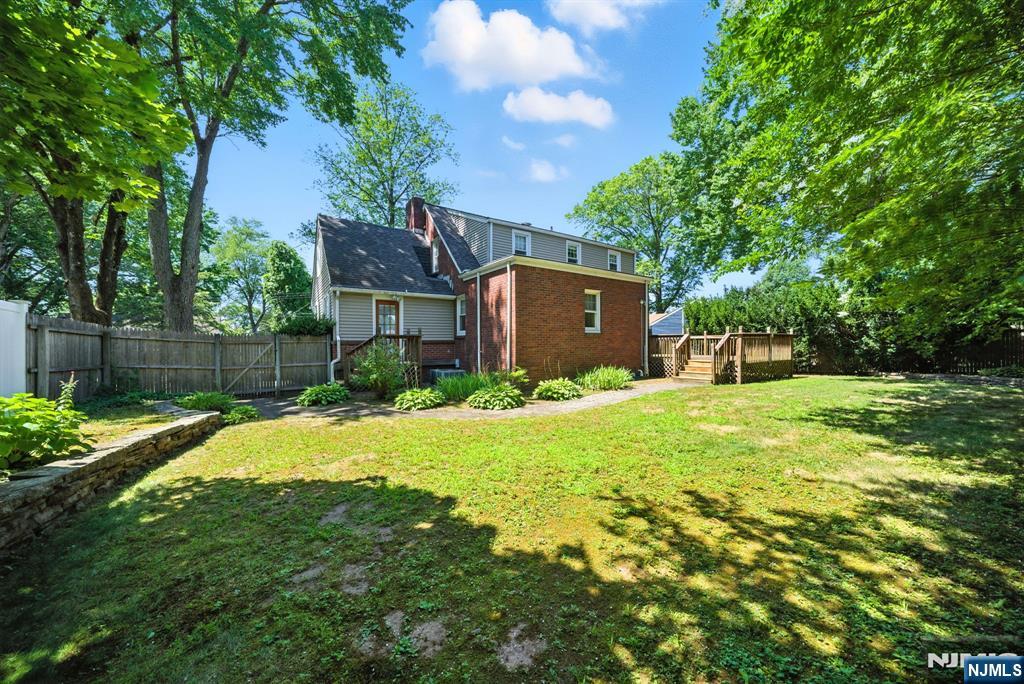25 Forest Street Closter, NJ 07624 - Photo 46 of 48 a view of a house with a yard and a garage