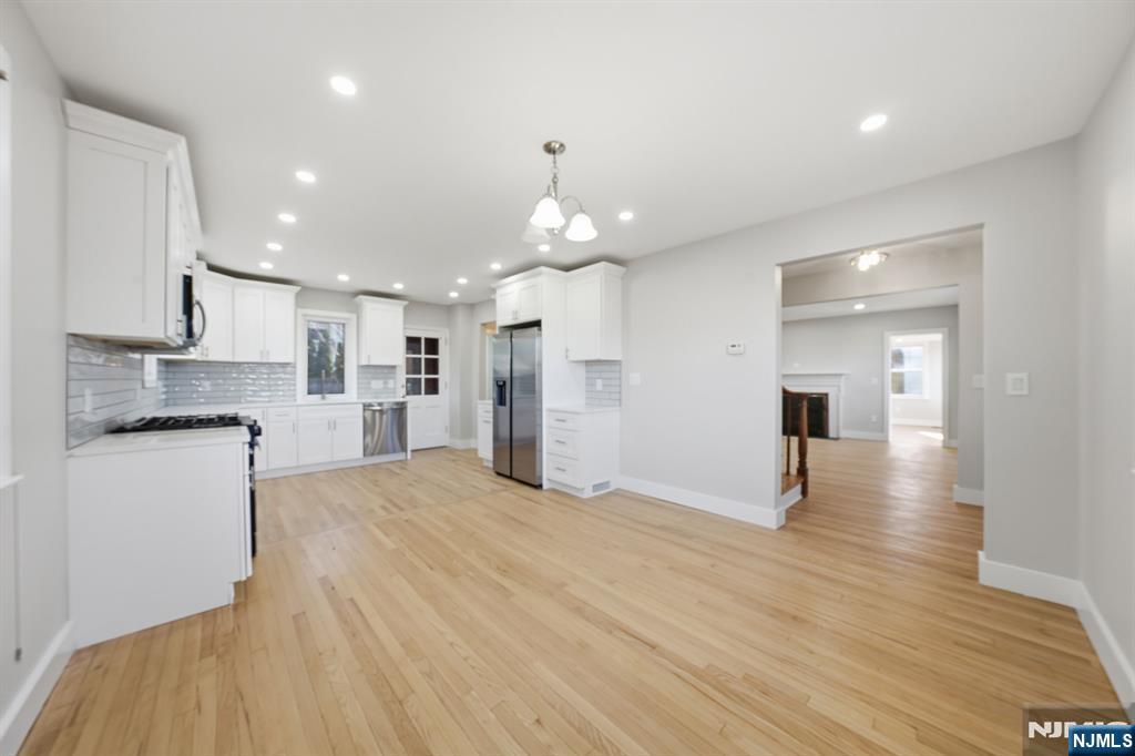 25 Forest Street Closter, NJ 07624 - Photo 5 of 48 a view of a kitchen with a sink and dishwasher a refrigerator with wooden floor