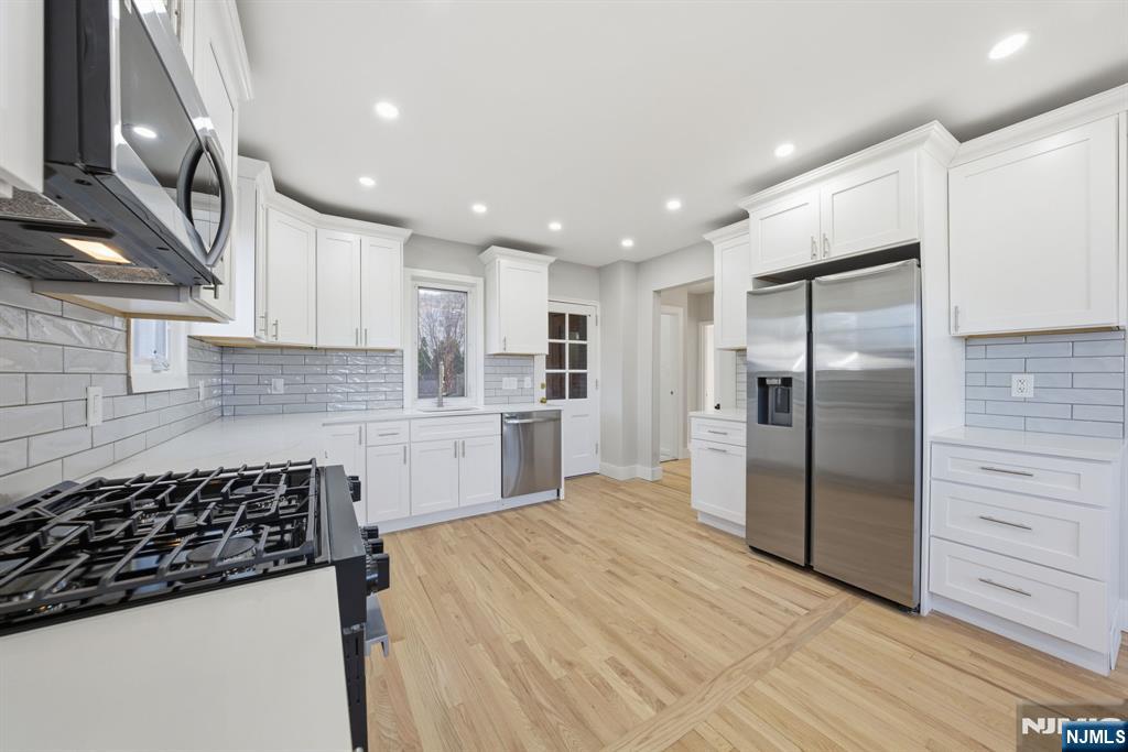 25 Forest Street Closter, NJ 07624 - Photo 6 of 48 a kitchen with refrigerator and cabinets
