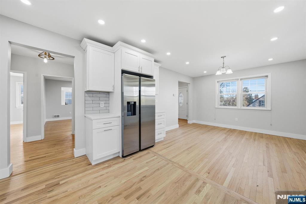 25 Forest Street Closter, NJ 07624 - Photo 7 of 48 a view of a kitchen with refrigerator and wooden floor
