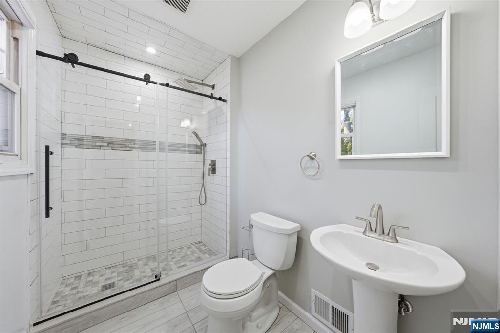 25 Forest Street Closter, NJ 07624 - Photo 9 of 48 a bathroom with a sink toilet and shower