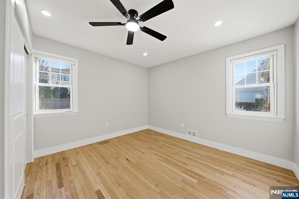 25 Forest Street Closter, NJ 07624 - Photo 10 of 48 an empty room with windows and fan
