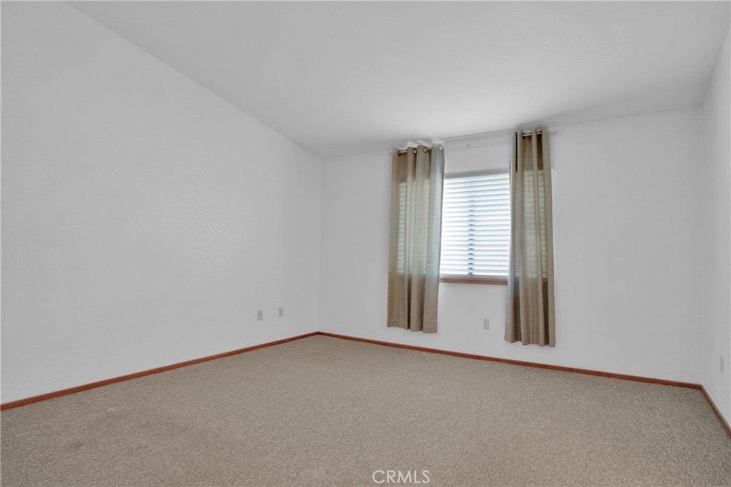 22544 Ojai Road Apple Valley, CA 92308 - Photo 11 of 20 an empty room with a window