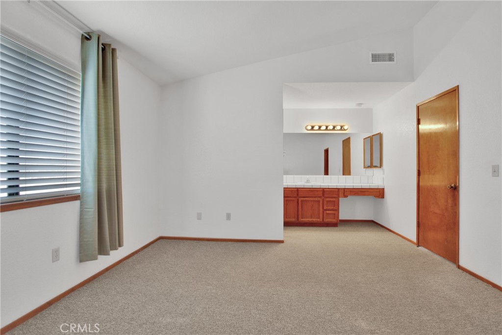 22544 Ojai Road Apple Valley, CA 92308 - Photo 13 of 20 a room with furniture and a window