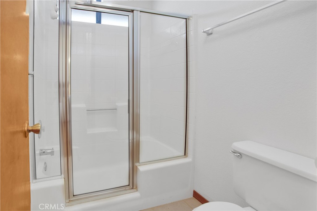 22544 Ojai Road Apple Valley, CA 92308 - Photo 15 of 20 a bathroom with a shower and a toilet