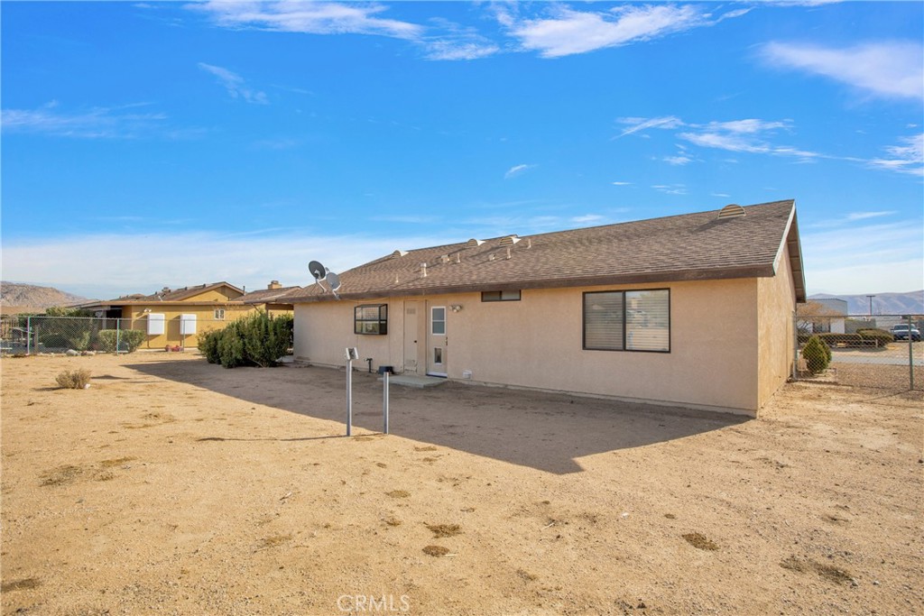 22544 Ojai Road Apple Valley, CA 92308 - Photo 19 of 20 a wooden house with a large tree in front of it