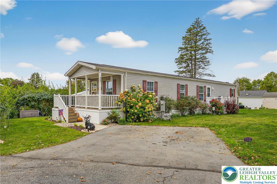 8792 Turkey Ridge Road Breinigsville, PA 18031 - Photo 2 of 33 a front view of a house with a yard and potted plants