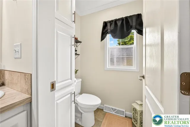 a white toilet sitting next to a bathroom sink