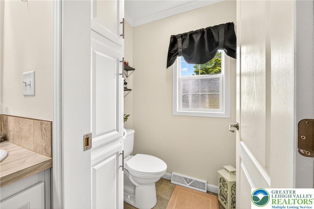 8792 Turkey Ridge Road Breinigsville, PA 18031 - Photo 21 of 33 a white toilet sitting next to a bathroom sink