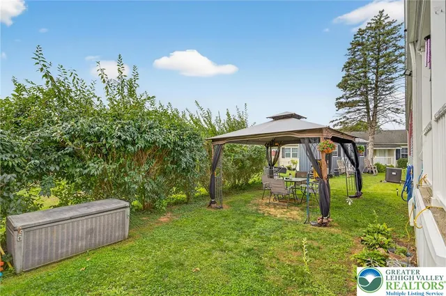 a backyard of a house with table and chairs
