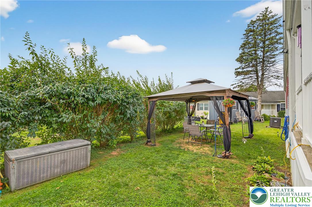 8792 Turkey Ridge Road Breinigsville, PA 18031 - Photo 23 of 33 a backyard of a house with table and chairs