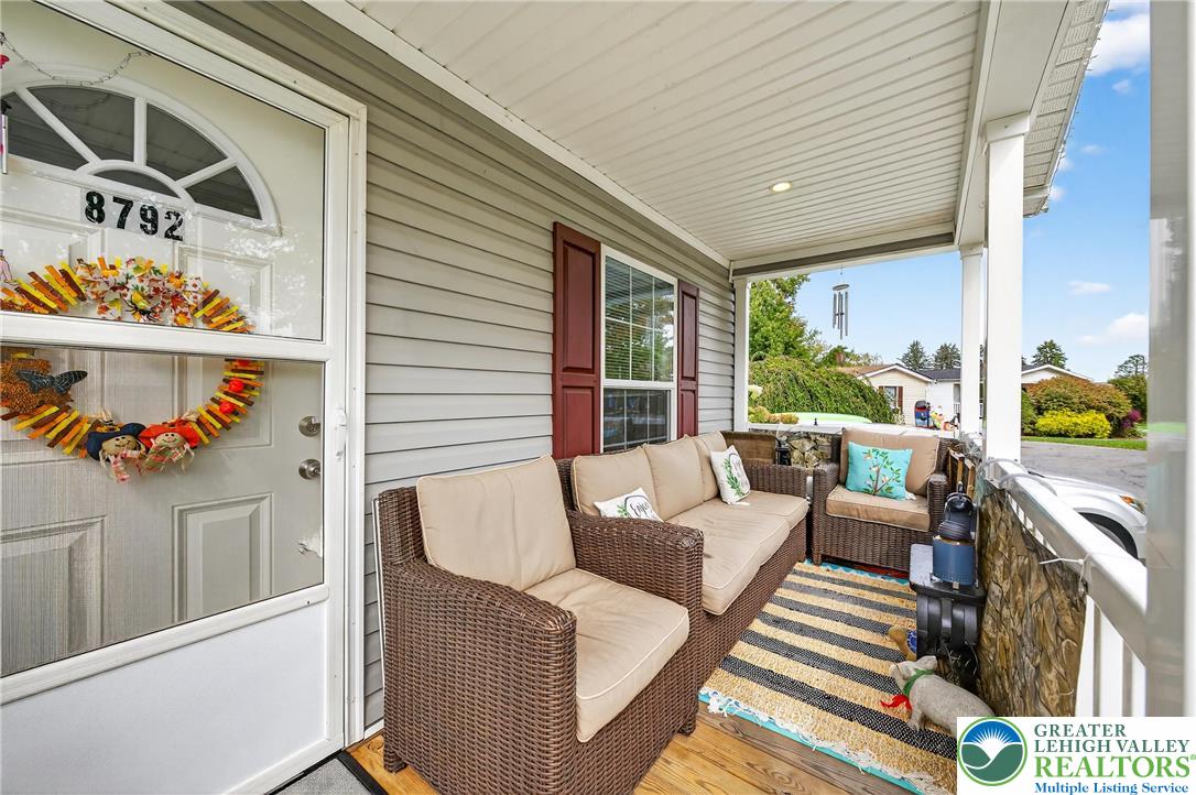 8792 Turkey Ridge Road Breinigsville, PA 18031 - Photo 4 of 33 a balcony with furniture and a potted plant
