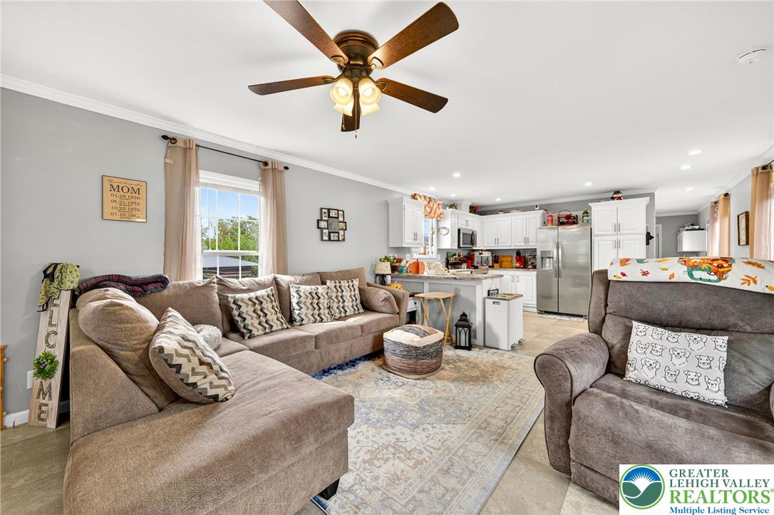 8792 Turkey Ridge Road Breinigsville, PA 18031 - Photo 5 of 33 a living room with furniture gym equipment and a large window