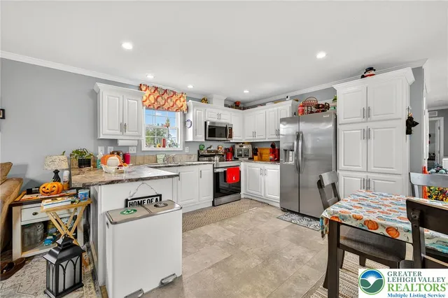 a kitchen with refrigerator and cabinets
