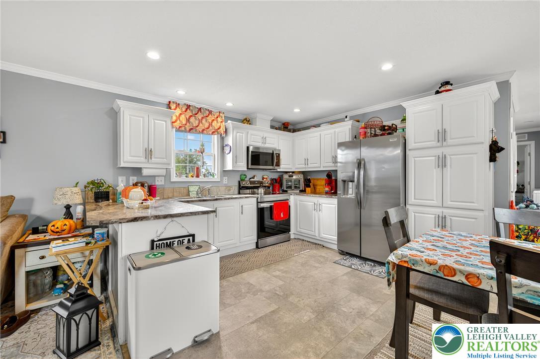 8792 Turkey Ridge Road Breinigsville, PA 18031 - Photo 8 of 33 a kitchen with refrigerator and cabinets