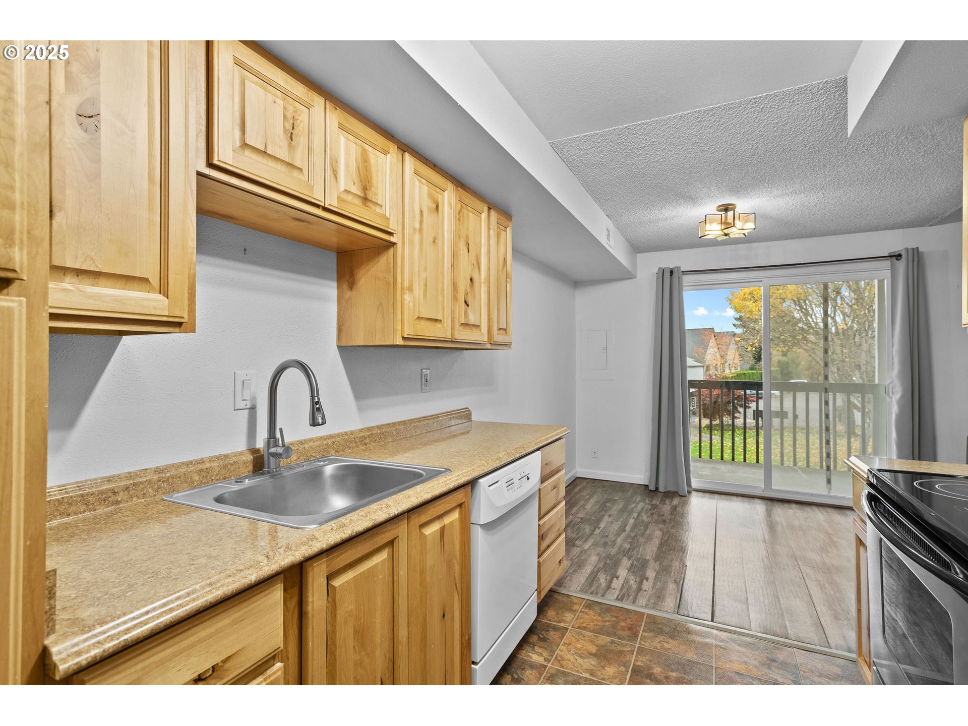 311 Northeast 85th Street, Unit R Vancouver, WA 98665 - Photo 16 of 34 a kitchen with a sink a counter top space and stainless steel appliances