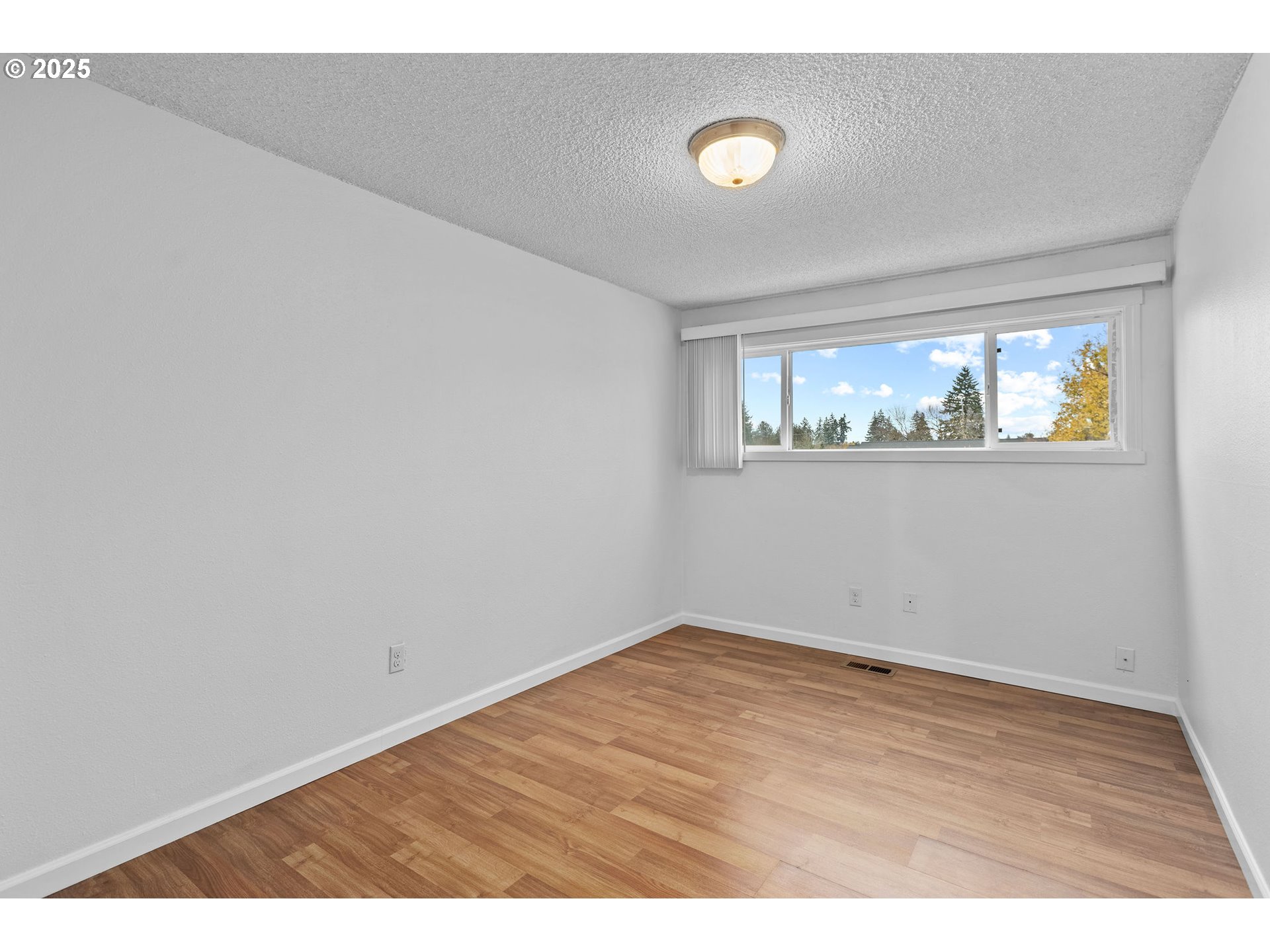 311 Northeast 85th Street, Unit R Vancouver, WA 98665 - Photo 23 of 34 an empty room with wooden floor and windows