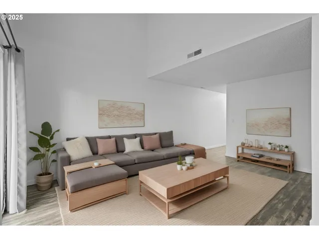 a living room with furniture and a potted plant