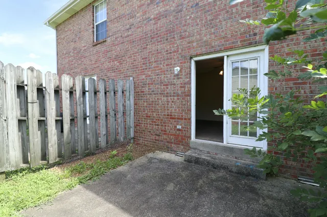 an empty room with a ceiling fan and carpet