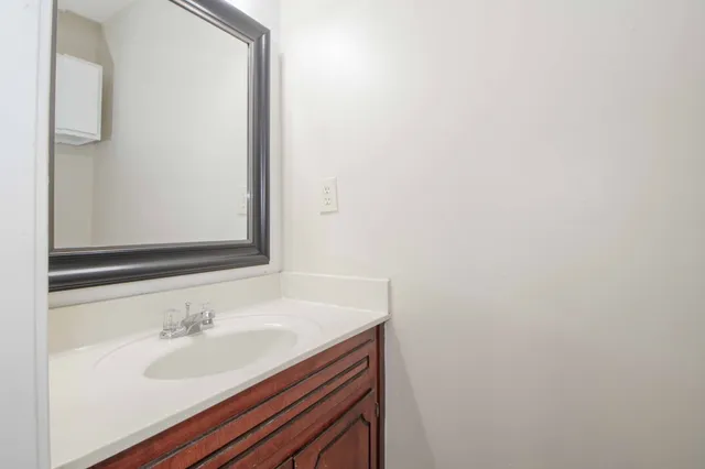 an empty room with a ceiling fan and window