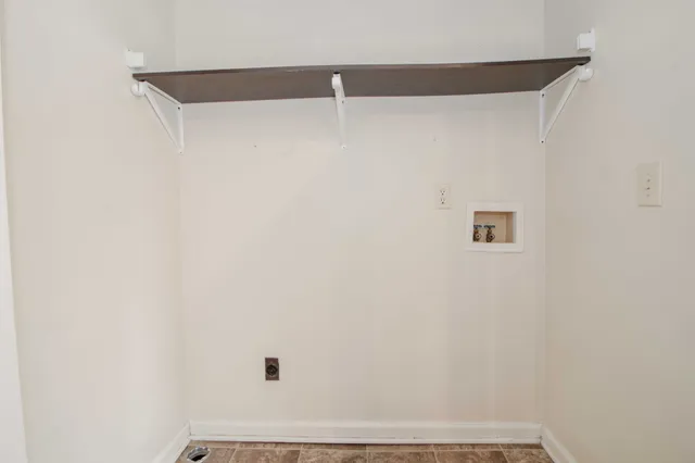 an empty room with a window and a ceiling fan