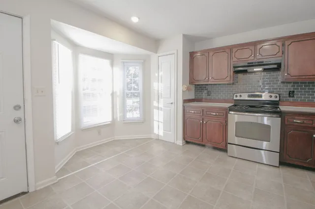 an empty room with a chandelier fan